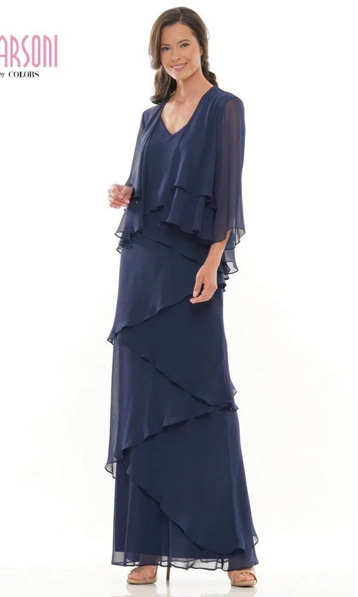 A woman wearing the Marsoni M309 long formal dress in navy blue chiffon with a matching sheer jacket, smiling against a white background.